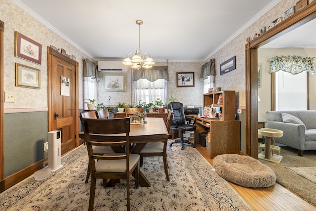 94 Union St, Bath, ME 04530 - dining space featuring wallpapered walls, wood-type flooring, a chandelier, a wall unit AC, and ornamental molding