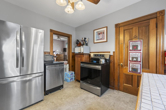 94 Union St, Bath, ME 04530 - kitchen with appliances with stainless steel finishes, a ceiling fan, brown cabinets, and light countertops