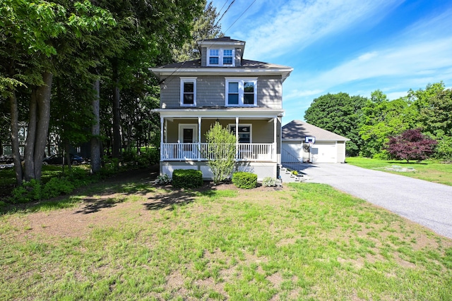 24 Western Ave, Auburn, ME 04210 - traditional style home with covered porch, a garage, a front yard, and an outbuilding