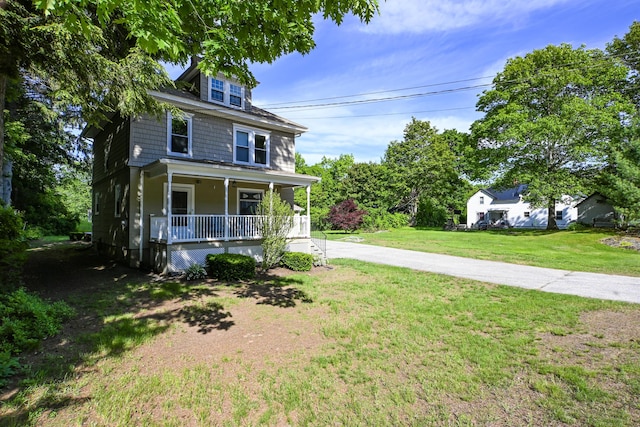 24 Western Ave, Auburn, ME 04210 - view of front of property featuring a porch and a front yard
