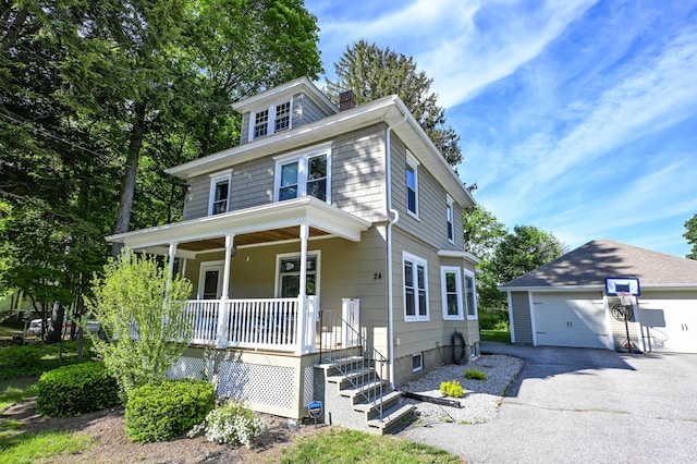 24 Western Ave, Auburn, ME 04210 - american foursquare style home featuring covered porch, an outbuilding, a chimney, and a detached garage