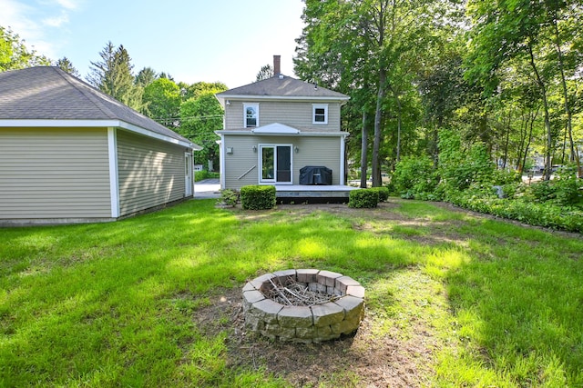 24 Western Ave, Auburn, ME 04210 - back of house featuring a fire pit, a deck, a yard, and a chimney