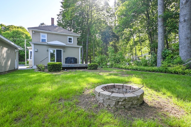 24 Western Ave, Auburn, ME 04210 - rear view of house featuring a fire pit and a chimney