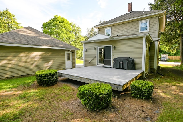 24 Western Ave, Auburn, ME 04210 - back of house with a chimney, a deck, and roof with shingles
