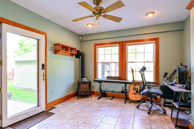 24 Western Ave, Auburn, ME 04210 - office featuring a wood stove, plenty of natural light, ceiling fan, and baseboards
