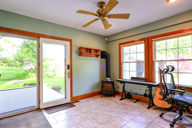 24 Western Ave, Auburn, ME 04210 - office featuring a wood stove, plenty of natural light, ceiling fan, and baseboards