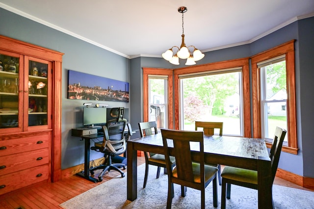 24 Western Ave, Auburn, ME 04210 - dining area with wood-type flooring, healthy amount of natural light, a chandelier, and crown molding