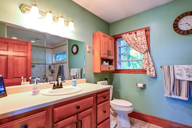 24 Western Ave, Auburn, ME 04210 - bathroom featuring toilet, tile patterned flooring, vanity, a shower, and baseboards