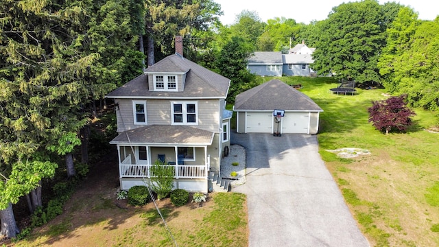 24 Western Ave, Auburn, ME 04210 - view of front of home with an outdoor structure, a porch, a garage, a front lawn, and a chimney
