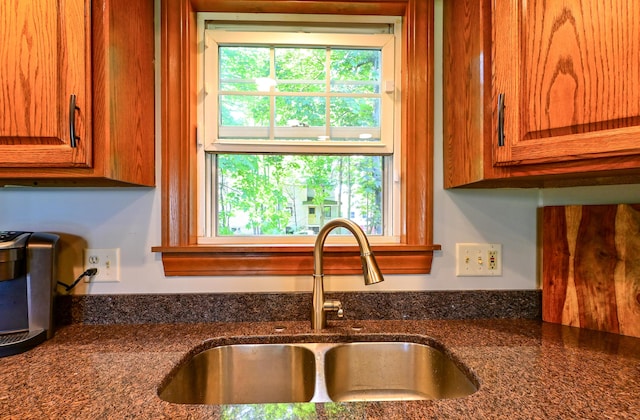 24 Western Ave, Auburn, ME 04210 - kitchen view of a sink, brown cabinets, and dark stone counters