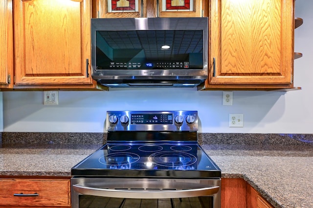 24 Western Ave, Auburn, ME 04210 - kitchen with stainless steel appliances, brown cabinets, and dark countertops
