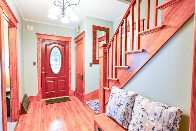 24 Western Ave, Auburn, ME 04210 - foyer featuring a chandelier, hardwood / wood-style floors, baseboards, ornamental molding, and stairs