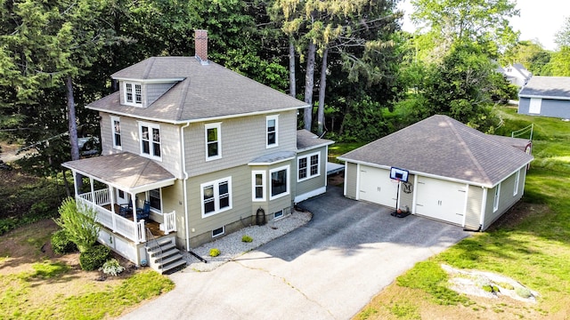 24 Western Ave, Auburn, ME 04210 - view of front of home featuring an outdoor structure, a porch, a chimney, a shingled roof, and a detached garage