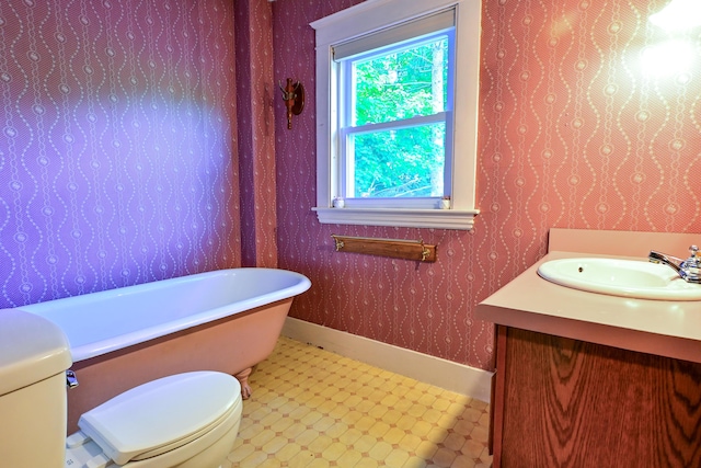 24 Western Ave, Auburn, ME 04210 - bathroom featuring a soaking tub, vanity, toilet, and tile patterned floors
