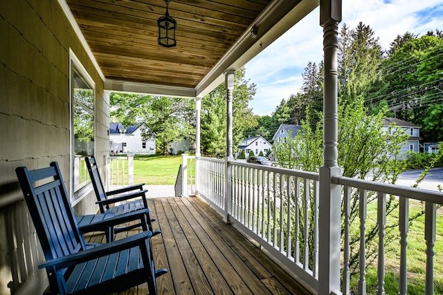 24 Western Ave, Auburn, ME 04210 - wooden porch featuring a residential view and a lawn