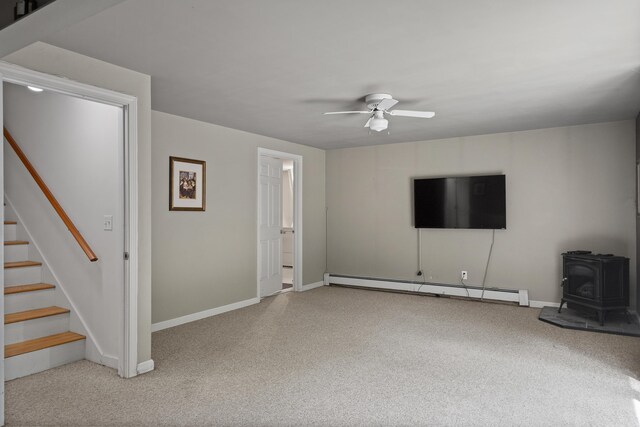 27 Russell Ln, Damariscotta, ME 04543 - unfurnished living room with a baseboard heating unit, carpet flooring, a ceiling fan, and stairway