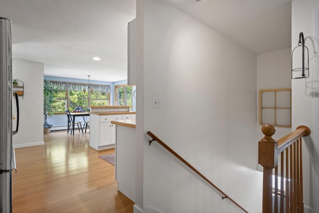 27 Russell Ln, Damariscotta, ME 04543 - hall featuring an upstairs landing, light wood finished floors, recessed lighting, a chandelier, and baseboard heating