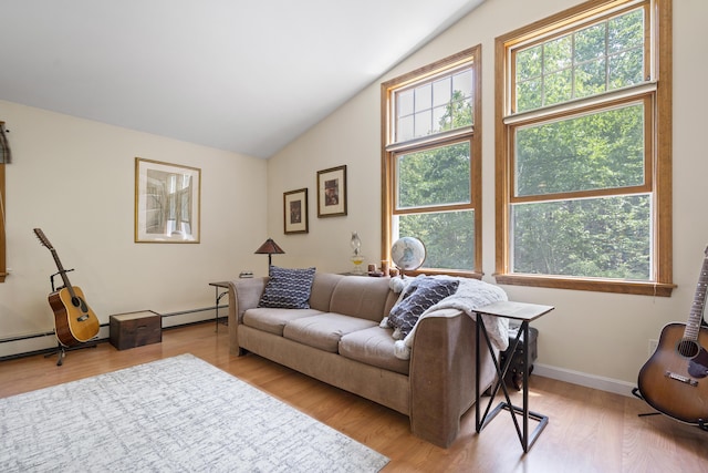 27 Russell Ln, Damariscotta, ME 04543 - living area featuring vaulted ceiling, healthy amount of natural light, a baseboard radiator, and light wood finished floors
