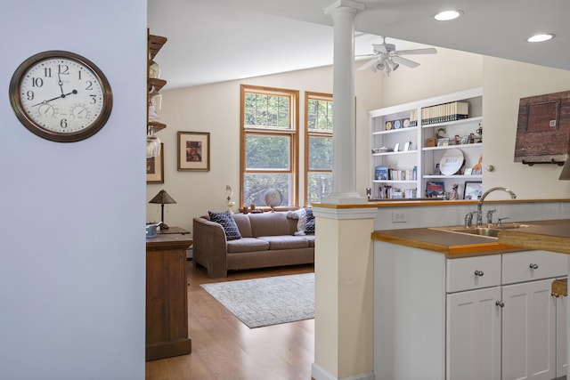 27 Russell Ln, Damariscotta, ME 04543 - kitchen with decorative columns, light wood-style floors, a ceiling fan, vaulted ceiling, and white cabinetry