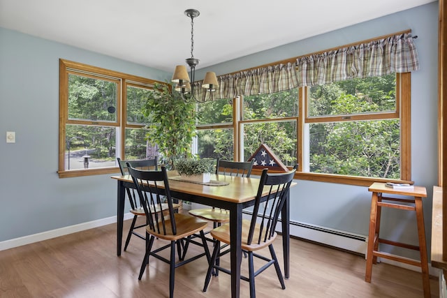 27 Russell Ln, Damariscotta, ME 04543 - dining area with a chandelier, wood finished floors, and a baseboard radiator