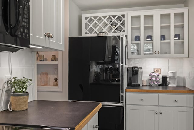 27 Russell Ln, Damariscotta, ME 04543 - kitchen with black appliances, dark countertops, decorative backsplash, and glass insert cabinets
