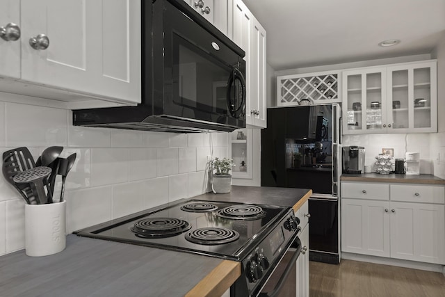 27 Russell Ln, Damariscotta, ME 04543 - kitchen with black appliances, tasteful backsplash, white cabinets, glass insert cabinets, and dark wood-style flooring