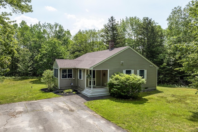 27 Russell Ln, Damariscotta, ME 04543 - view of front of home with a chimney, a front lawn, a shingled roof, and a porch