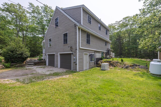 76 Punkintown Rd, Eliot, ME 03903 - view of side of property with a garage and a lawn
