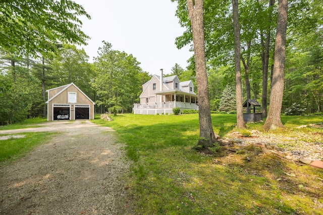 76 Punkintown Rd, Eliot, ME 03903 - view of green lawn with a detached garage, driveway, and an outbuilding