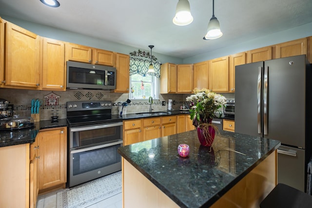 76 Punkintown Rd, Eliot, ME 03903 - kitchen featuring appliances with stainless steel finishes, hanging light fixtures, tasteful backsplash, a kitchen island, and dark stone counters