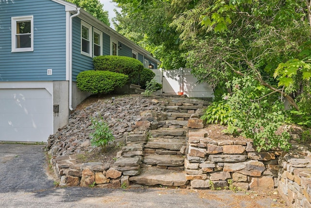 11 Meadow Ln, Portland, ME 04103 - view of side of home featuring a garage and driveway