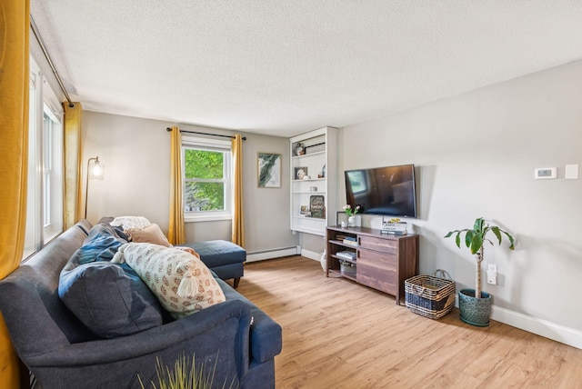 11 Meadow Ln, Portland, ME 04103 - living area with a baseboard radiator, light wood-style flooring, baseboards, and a textured ceiling
