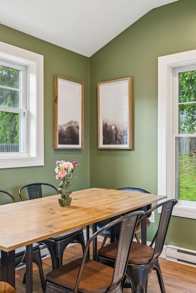 11 Meadow Ln, Portland, ME 04103 - dining space with healthy amount of natural light, vaulted ceiling, wood finished floors, and a baseboard radiator