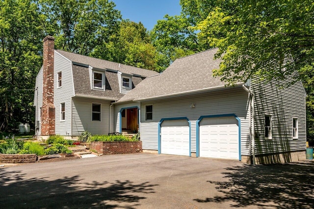 44 Pine Meadow Ct, North Berwick, ME 03906 - colonial inspired home featuring an attached garage, a chimney, asphalt driveway, and roof with shingles