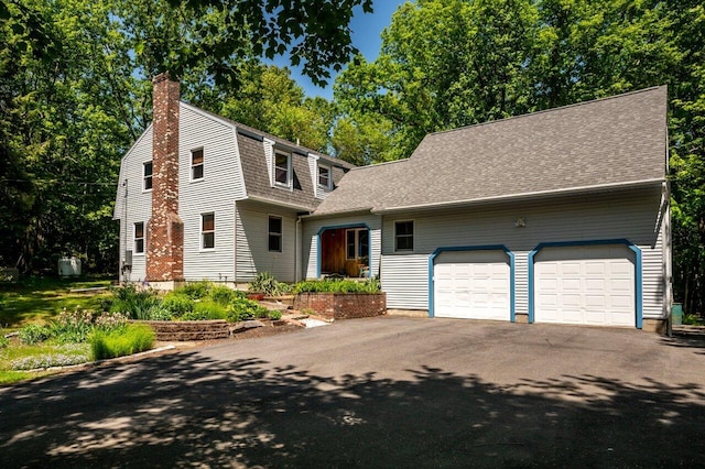 44 Pine Meadow Ct, North Berwick, ME 03906 - dutch colonial featuring a chimney, an attached garage, asphalt driveway, and roof with shingles