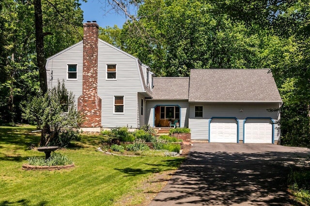 44 Pine Meadow Ct, North Berwick, ME 03906 - view of front facade with a chimney, driveway, an attached garage, a front yard, and a shingled roof