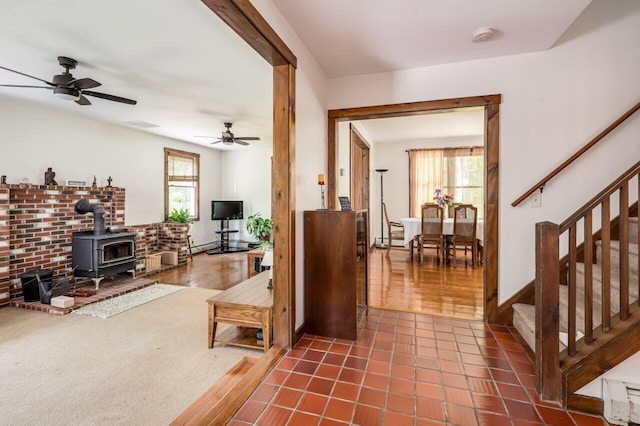 44 Pine Meadow Ct, North Berwick, ME 03906 - living area with a wood stove, ceiling fan, and stairs