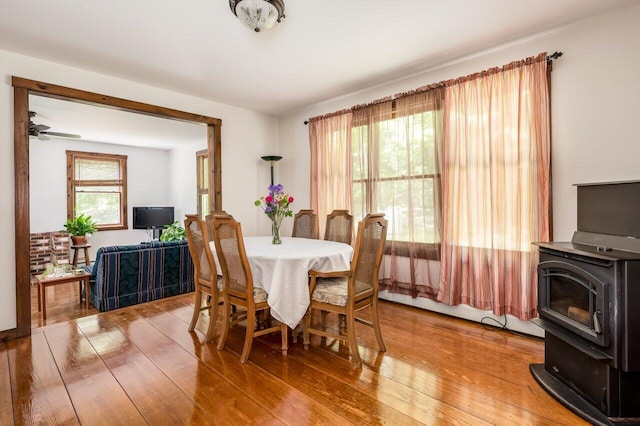 44 Pine Meadow Ct, North Berwick, ME 03906 - dining space featuring a wood stove, light wood-style floors, and a ceiling fan