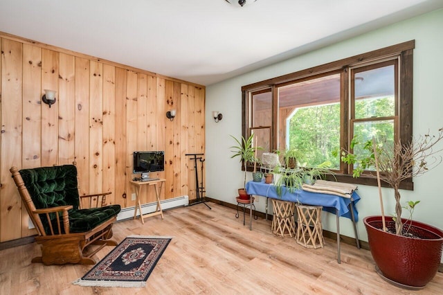 44 Pine Meadow Ct, North Berwick, ME 03906 - living area with baseboard heating, wood finished floors, baseboards, and wooden walls