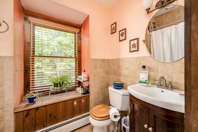 44 Pine Meadow Ct, North Berwick, ME 03906 - full bath featuring tile walls, vanity, toilet, baseboard heating, and a wainscoted wall