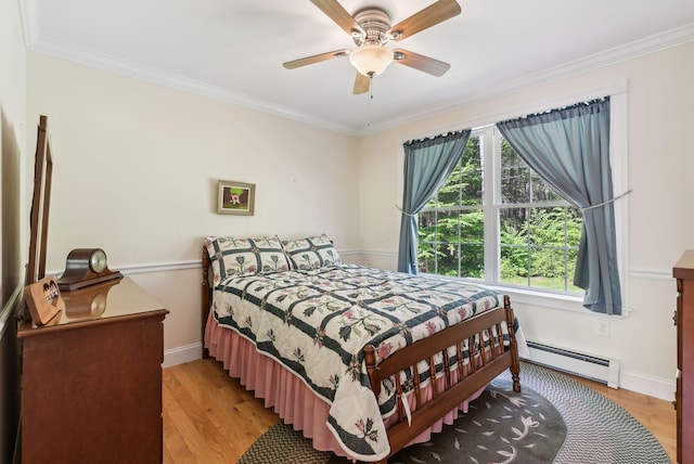 50 Village Green Drive Extension, Ogunquit, ME 03907 - bedroom featuring a baseboard radiator, ornamental molding, light wood finished floors, baseboards, and a ceiling fan