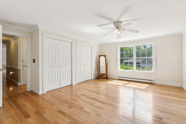 50 Village Green Drive Extension, Ogunquit, ME 03907 - unfurnished bedroom with a baseboard radiator, two closets, light wood-type flooring, ornamental molding, and baseboards