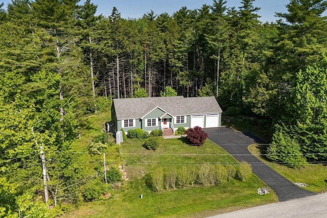 50 Village Green Drive Extension, Ogunquit, ME 03907 - ranch-style home featuring driveway, an attached garage, and a forest view