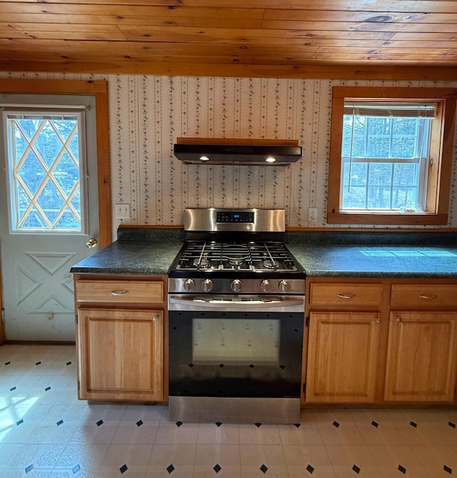 65 Pine Ridge Rd, Cushing, ME 04563 - kitchen with stainless steel range with gas stovetop, wood ceiling, healthy amount of natural light, wallpapered walls, and dark countertops