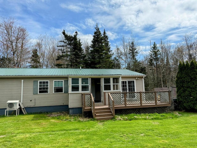 65 Pine Ridge Rd, Cushing, ME 04563 - back of property featuring a deck, a lawn, and metal roof