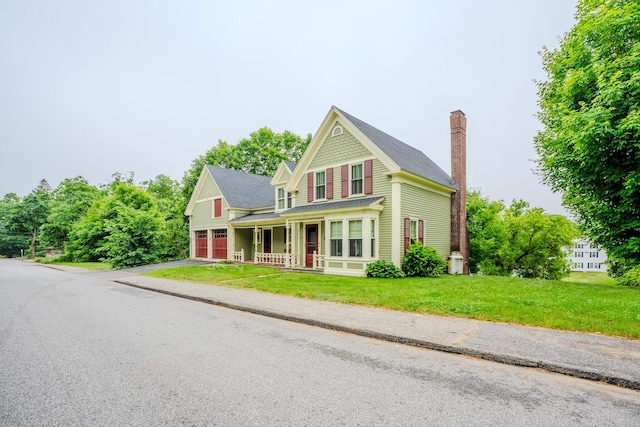 24 High St, Livermore Falls, ME 04254 - victorian house featuring a porch, driveway, a chimney, a front yard, and a garage