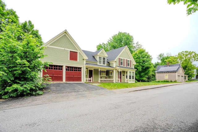24 High St, Livermore Falls, ME 04254 - victorian-style house featuring a porch, asphalt driveway, and an attached garage