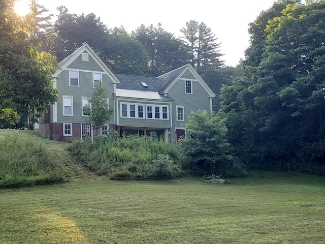 24 High St, Livermore Falls, ME 04254 - rear view of property with a lawn and a metal roof