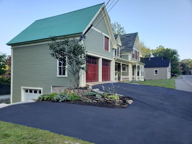 24 High St, Livermore Falls, ME 04254 - view of front facade with asphalt driveway, a garage, and a porch