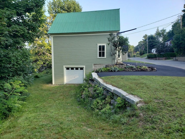 24 High St, Livermore Falls, ME 04254 - view of home's exterior with a yard, an attached garage, a metal roof, and driveway
